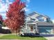 Charming two-story home with inviting curb appeal, featuring manicured lawn and vibrant autumn foliage at 9011 Sandpiper Dr, Longmont, CO 80504