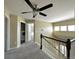 Hallway featuring carpet floors and providing access to the laundry room and bedrooms at 9011 Sandpiper Dr, Longmont, CO 80504