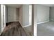 Basement hallway featuring hardwood floors that connect to carpeted area and a bedroom door at 9011 Sandpiper Dr, Longmont, CO 80504