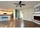 Open-concept living area with hardwood floors, fireplace and adjacent kitchen at 9011 Sandpiper Dr, Longmont, CO 80504