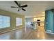 Open living room featuring hardwood floors, large windows and modern ceiling fan at 9011 Sandpiper Dr, Longmont, CO 80504