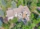 An aerial view showcasing a large home with a stone fireplace and expansive decks at 6325 E Tufts Ave, Cherry Hills Village, CO 80111