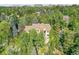 Aerial view of house nestled among lush trees at 6325 E Tufts Ave, Cherry Hills Village, CO 80111