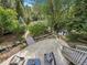 Spacious backyard patio with seating area, overlooking a tranquil stream and lush landscaping at 6325 E Tufts Ave, Cherry Hills Village, CO 80111