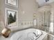 Elegant bathroom with soaking tub, walk-in shower, and views at 6325 E Tufts Ave, Cherry Hills Village, CO 80111