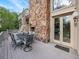 Deck with stone fireplace and seating area, perfect for outdoor dining and relaxation at 6325 E Tufts Ave, Cherry Hills Village, CO 80111