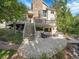 Two-story house exterior with stone fireplace and deck, offering a charming curb appeal at 6325 E Tufts Ave, Cherry Hills Village, CO 80111