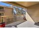 A sunny, covered balcony with wood trim and railings offers relaxing outdoor living at 4064 S Atchison Way # 204, Aurora, CO 80014