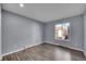 Bedroom with a large window and wood-look flooring, with neutral paint at 4064 S Atchison Way # 204, Aurora, CO 80014