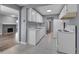 Functional kitchen with white cabinetry, tile flooring, and modern appliances, next to a dining area at 4064 S Atchison Way # 204, Aurora, CO 80014