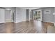 Bright living room featuring hardwood floors, neutral paint, and a sliding glass door to a balcony at 4064 S Atchison Way # 204, Aurora, CO 80014