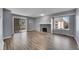 Bright living room featuring a stone fireplace, sliding glass doors and wood-look flooring at 4064 S Atchison Way # 204, Aurora, CO 80014