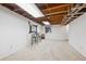 Spacious basement with neutral carpet, exposed ceiling, and small window at 8010 Holland Ct # D, Arvada, CO 80005