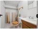 Unfinished bathroom with a wood vanity, mirror, toilet, and closet for storage at 8010 Holland Ct # D, Arvada, CO 80005
