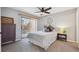 A cozy bedroom features a sliding glass door to the patio and a modern ceiling fan at 8010 Holland Ct # D, Arvada, CO 80005