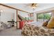 Open concept bedroom features a seating area, TV, and large sliding glass doors at 8010 Holland Ct # D, Arvada, CO 80005
