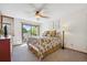 Comfortable bedroom with a sliding glass door and outdoor view and floral decor at 8010 Holland Ct # D, Arvada, CO 80005