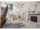 Open-concept living area with fireplace and views of the kitchen and upper level at 8010 Holland Ct # D, Arvada, CO 80005