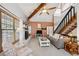 Bright living room with large windows, brick fireplace, comfortable seating, and staircase access at 8010 Holland Ct # D, Arvada, CO 80005