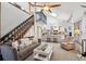 Open concept living area showcasing the staircase, fireplace, and kitchen at 8010 Holland Ct # D, Arvada, CO 80005