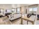 Open concept dining area with wood table and white chairs at 1465 Bloom St, Brighton, CO 80601