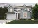 Two-story house with gray siding, attached garage, and landscaping at 1465 Bloom St, Brighton, CO 80601