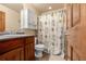 Clean bathroom with wood cabinets and a shower/tub combo at 7562 E 130Th Cir, Thornton, CO 80602