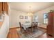 Formal dining room with hardwood floors, chandelier and seating for six at 7562 E 130Th Cir, Thornton, CO 80602