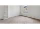 Well-lit bedroom with carpet, large window and built-in shelving at 7944 E Lowry Blvd, Denver, CO 80230