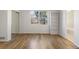 Bright bedroom with hardwood floors, large window, and mirrored closet at 7944 E Lowry Blvd, Denver, CO 80230