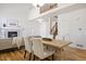 The dining area is connected to the living room and features a fireplace, wooden floors, and staircase at 7944 E Lowry Blvd, Denver, CO 80230