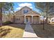 Inviting front yard with walkway leading up to a home with a covered porch at 7944 E Lowry Blvd, Denver, CO 80230