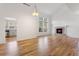 Bright living room boasts a fireplace, hardwood floors, and vaulted ceiling with clerestory windows at 7944 E Lowry Blvd, Denver, CO 80230