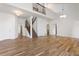 Bright and airy living room with hardwood floors, high ceilings, and staircase at 7944 E Lowry Blvd, Denver, CO 80230