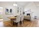 Inviting living and dining area with hardwood floors, fireplace, and large window at 7944 E Lowry Blvd, Denver, CO 80230