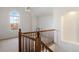 Loft with arched window, wood railing, and a ceiling fan at 7944 E Lowry Blvd, Denver, CO 80230