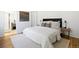 Cozy main bedroom with neutral tones, a patterned rug, and an ensuite bathroom with a glass-enclosed shower at 7944 E Lowry Blvd, Denver, CO 80230