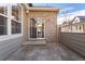 Private patio with brick wall and sliding door access at 7944 E Lowry Blvd, Denver, CO 80230