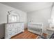 Well-lit bedroom with a crib and dresser at 6505 Kalua Rd # 204B, Boulder, CO 80301