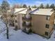 Side view of condo building with balconies and snow at 6505 Kalua Rd # 204B, Boulder, CO 80301