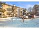 Exterior view of condo building with snow covered landscaping and parking at 6505 Kalua Rd # 204B, Boulder, CO 80301