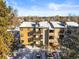 Condo building exterior view showing snow and landscaping at 6505 Kalua Rd # 204B, Boulder, CO 80301