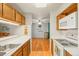 Open kitchen with white appliances, wood cabinets and view of the living room at 6505 Kalua Rd # 204B, Boulder, CO 80301