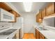 Kitchen with white appliances, wood cabinets, and a double sink at 6505 Kalua Rd # 204B, Boulder, CO 80301