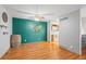 Living room with hardwood floors, decorative shelves, and a world map accent wall at 6505 Kalua Rd # 204B, Boulder, CO 80301