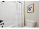 A full bathroom features a tub and shower combo and a toilet, with a gold-framed picture on the wall at 20223 Terrace View Dr, Parker, CO 80134