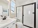 Bright bathroom with a shower and toilet and a sleek glass door and black trim at 20223 Terrace View Dr, Parker, CO 80134