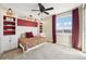 Cozy bedroom with built-in shelving, a comfortable bed, and large windows at 20223 Terrace View Dr, Parker, CO 80134