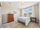 Cozy bedroom with plush carpet, dresser, and a large window providing ample natural light at 20223 Terrace View Dr, Parker, CO 80134