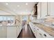 Bright kitchen featuring white cabinets, granite countertops, and stainless steel appliances at 20223 Terrace View Dr, Parker, CO 80134